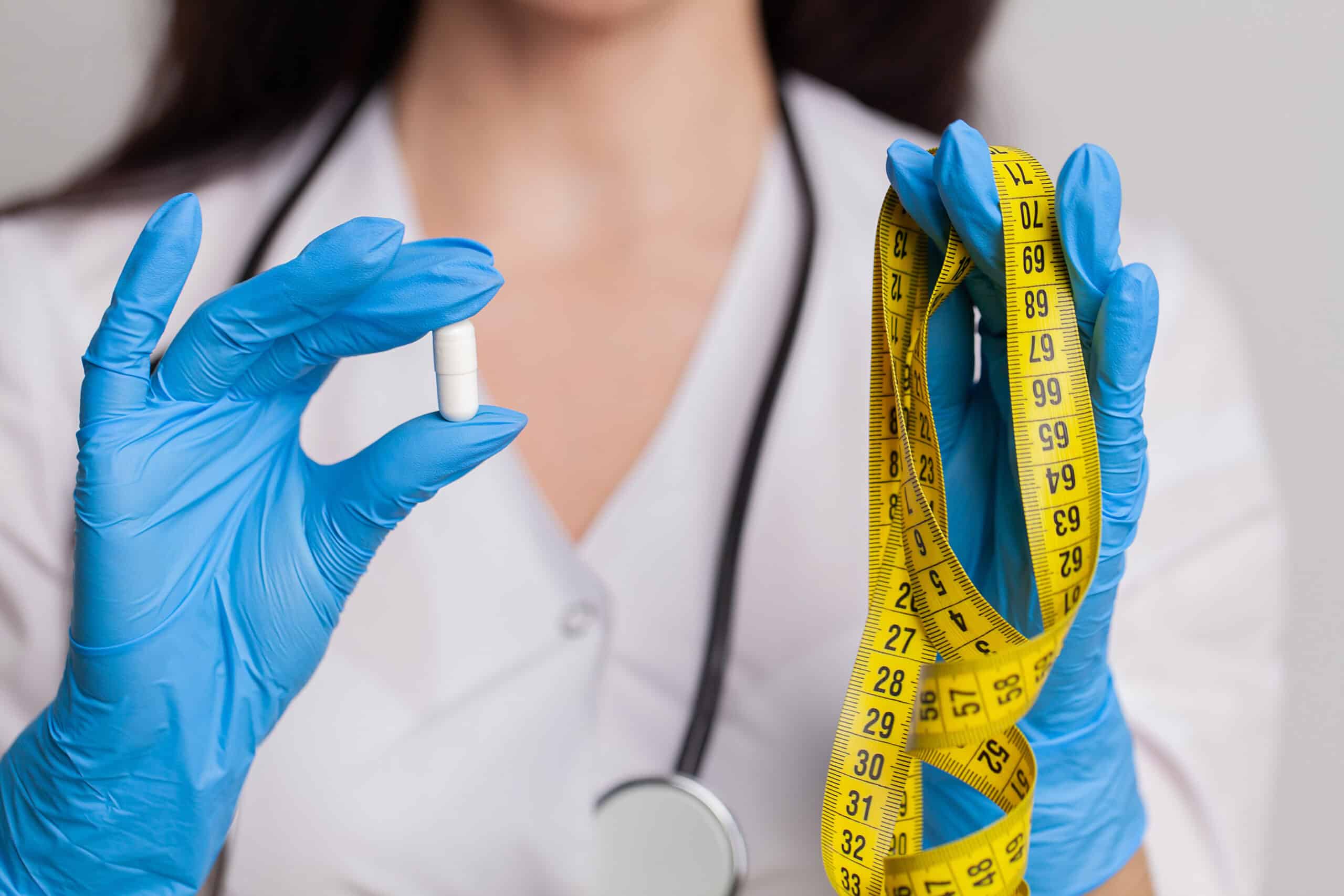 doctor close up holding white pills for weight los 2025 02 13 19 39 16 utc scaled